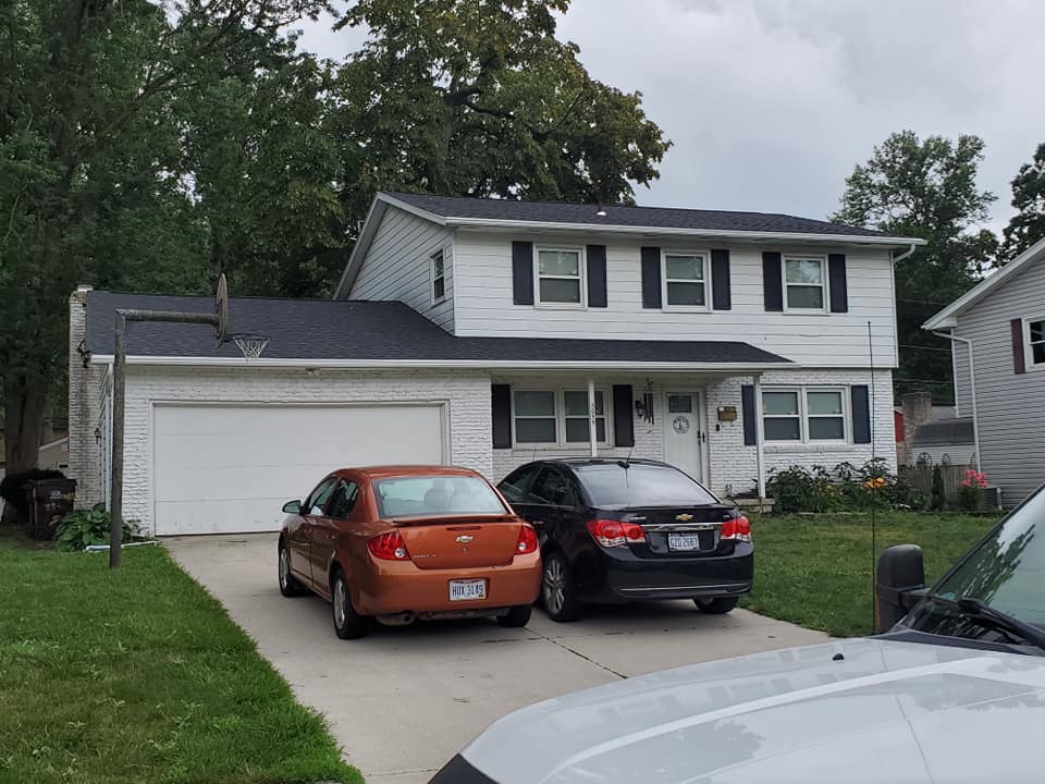 New roofs with two cars parked outside