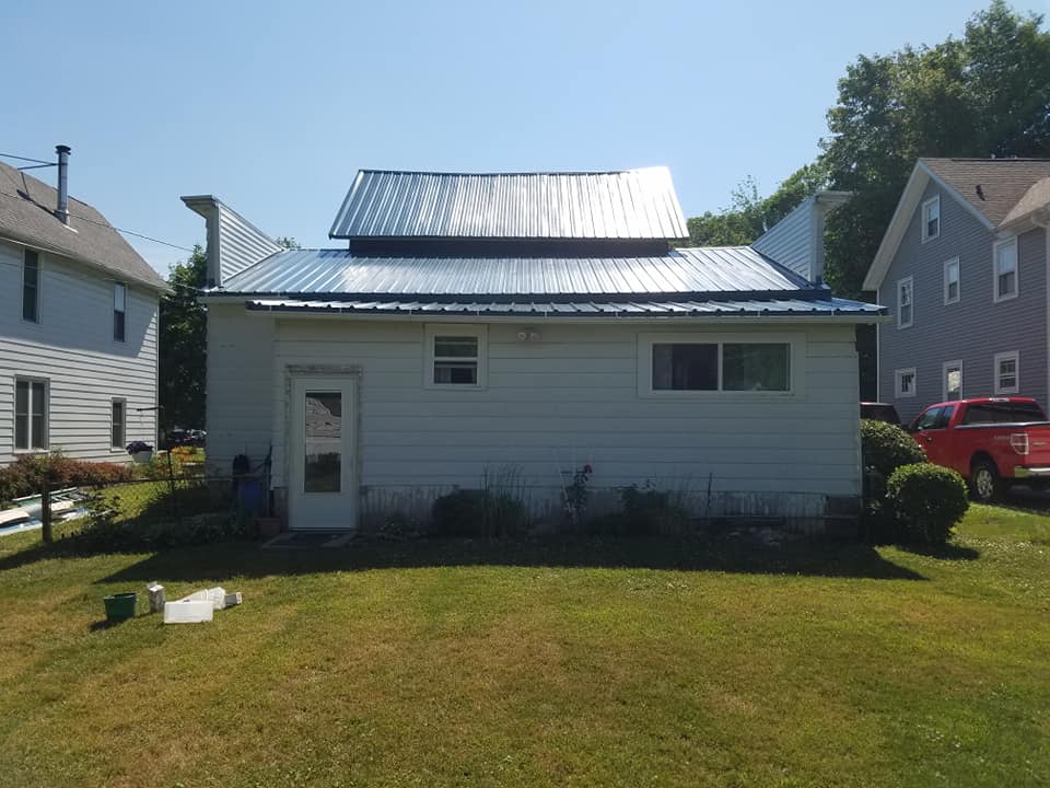 Metal roof and white siding
