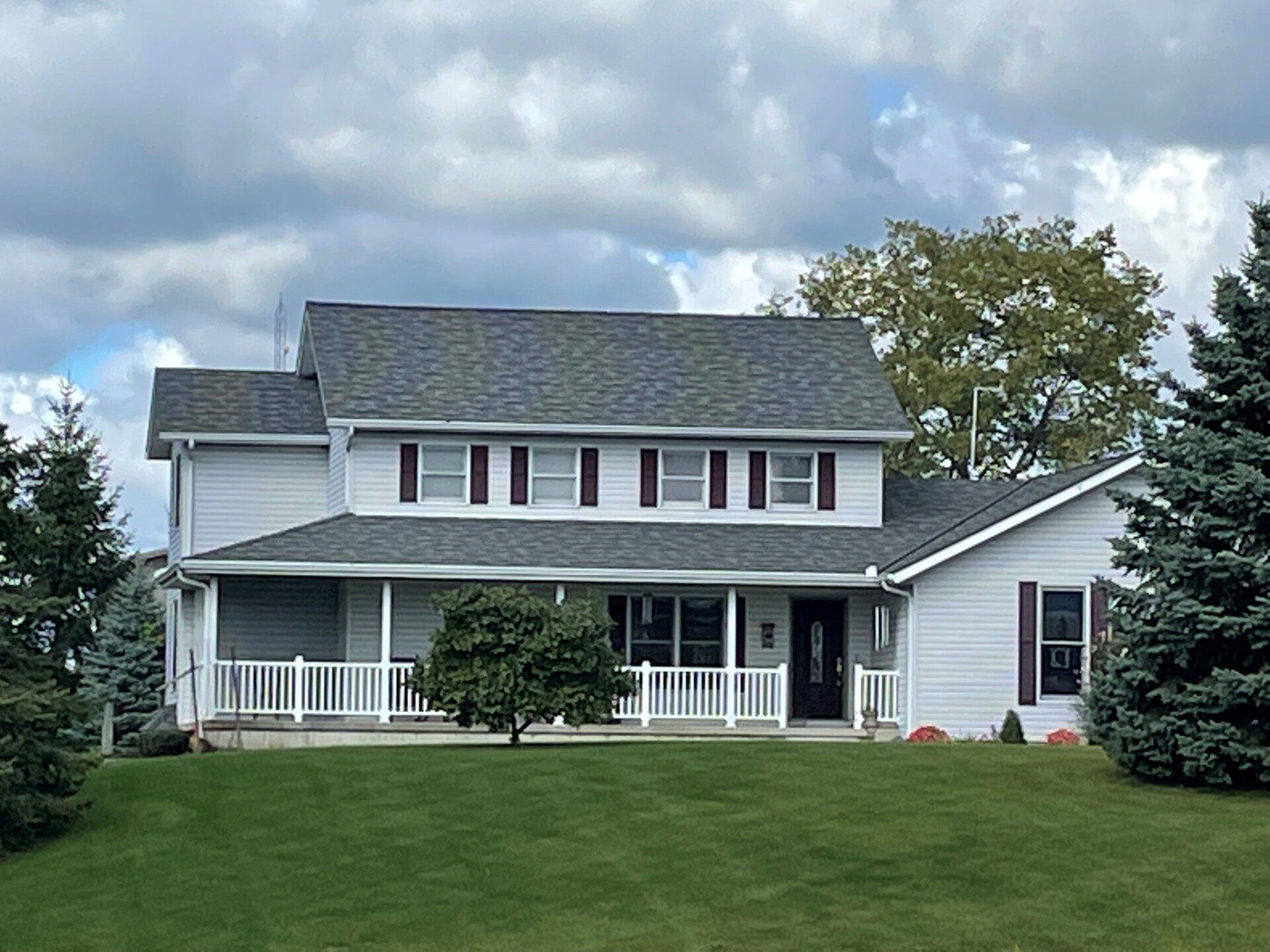 House with asphalt roofing and white siding