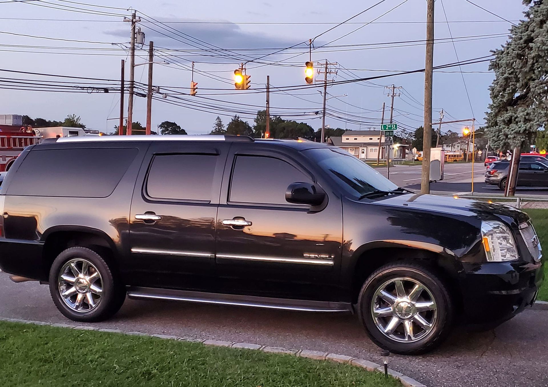 A black suv is parked on the side of the road.