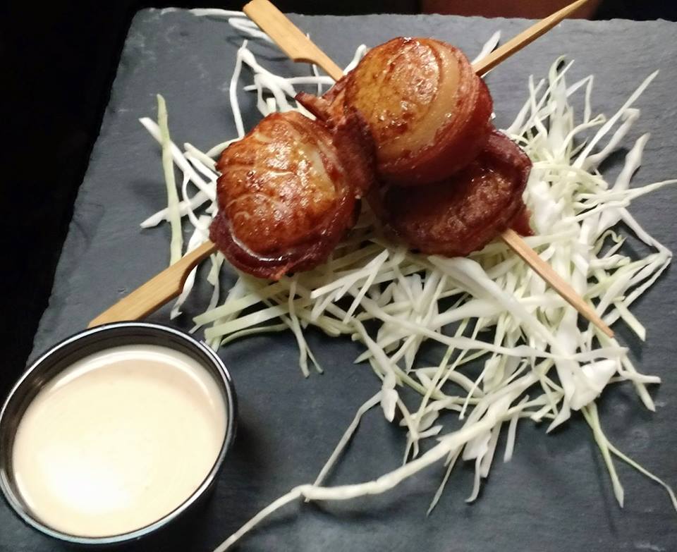 A plate of food with a bowl of dipping sauce