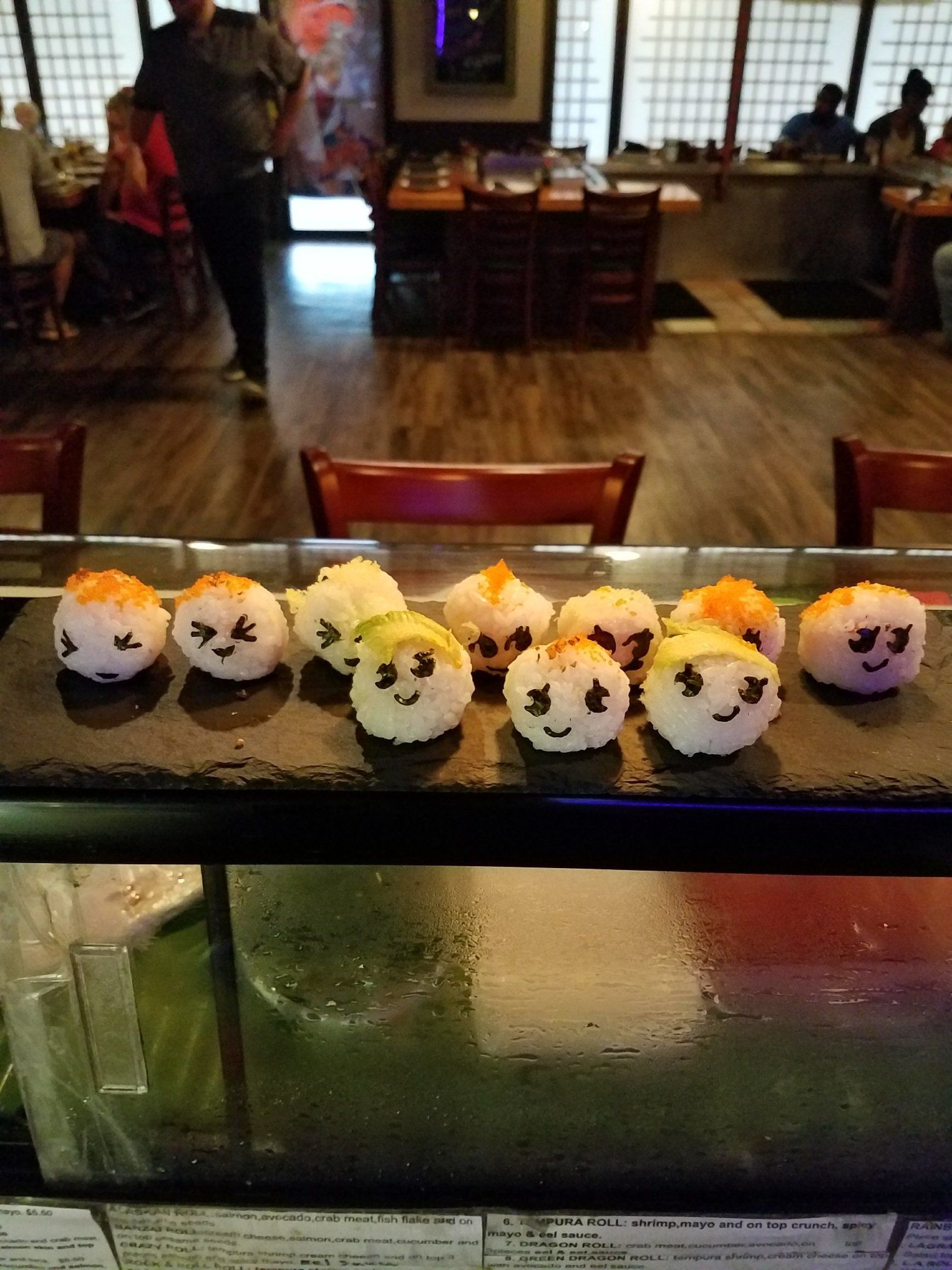 A tray of sushi with faces drawn on them