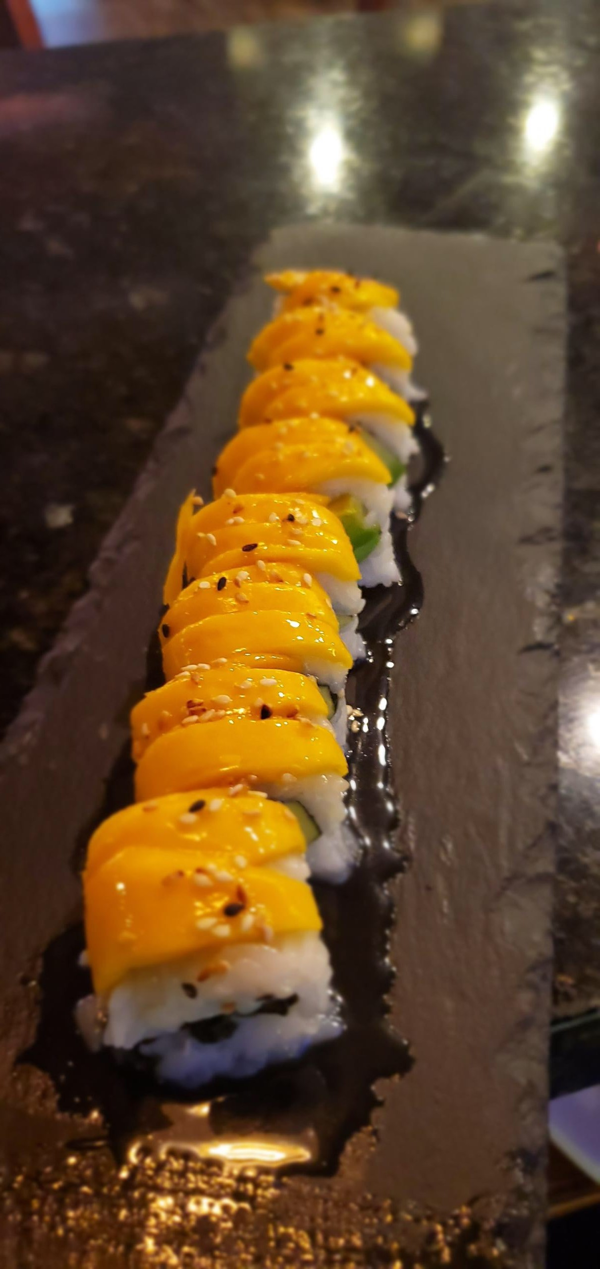 A close up of a tray of sushi on a table.