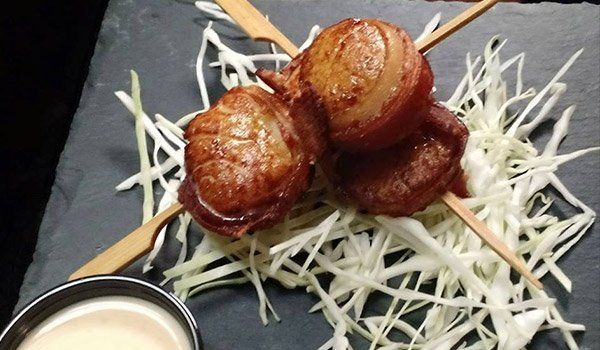A close up of a plate of food with a dipping sauce