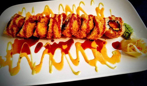 A close up of a plate of food with sauce on it.