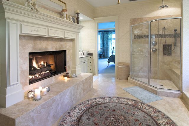 A bathroom with a fireplace and a shower.