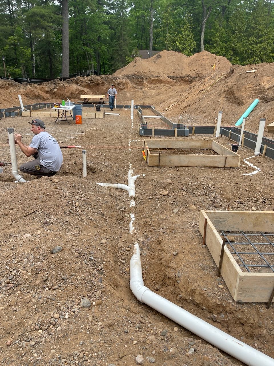 A man is working in the dirt on a construction site