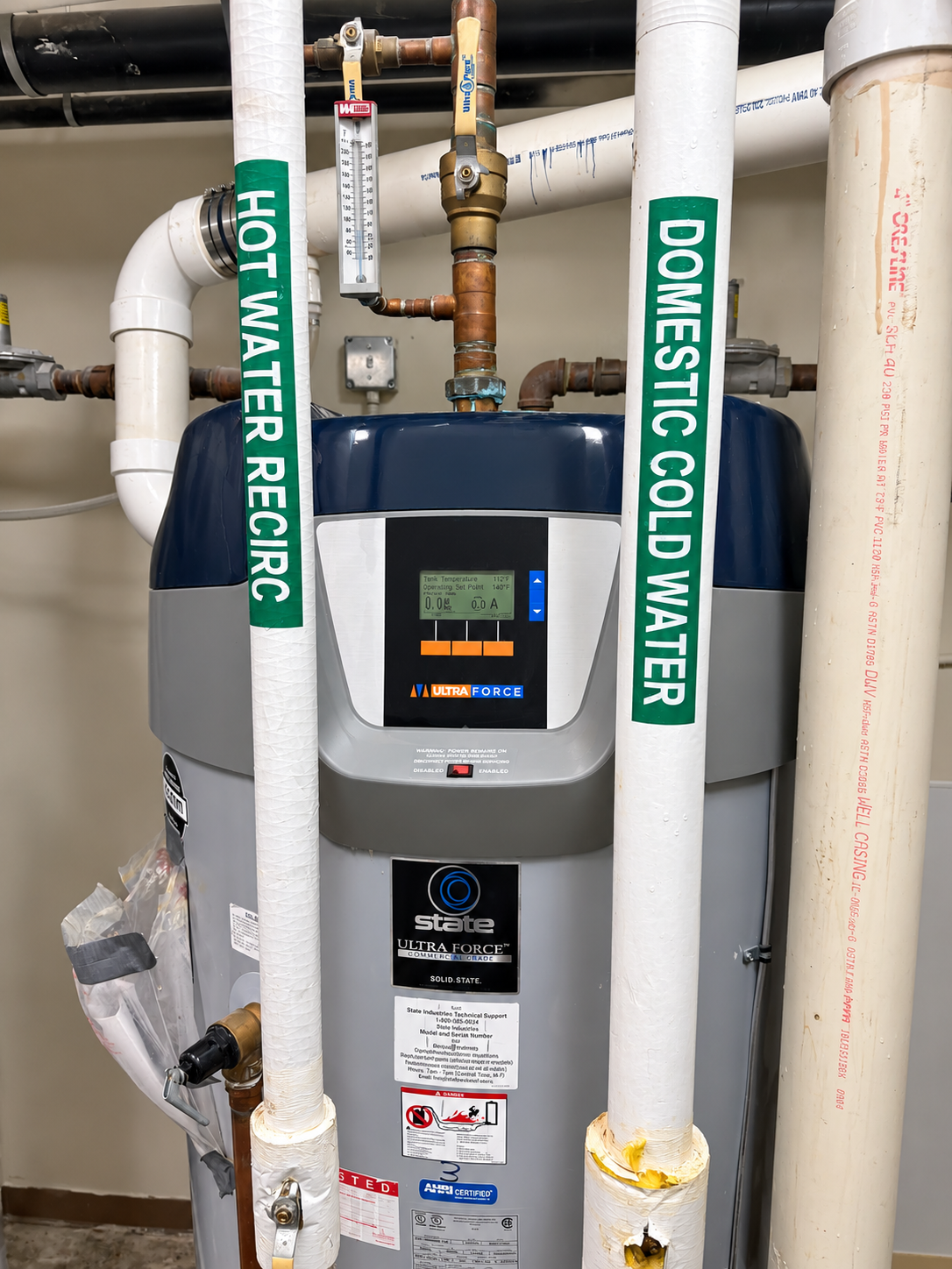Water heater with hot water recirc and domestic cold water pipes in a utility room