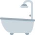 A white bathtub with a curved faucet and shower head