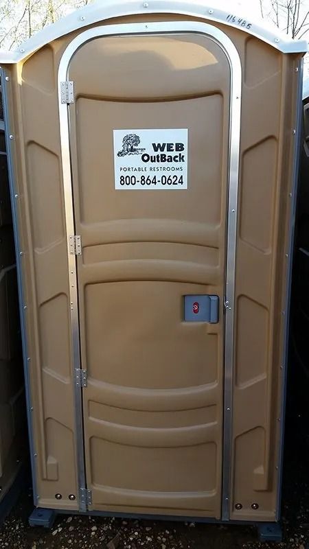 A brown portable toilet with a sign on the door that says web outdoor