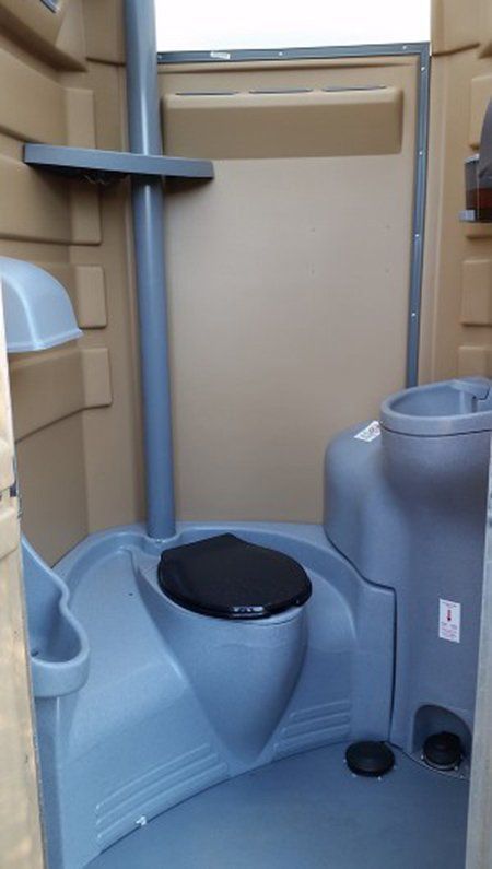 A portable toilet with a black seat and a sink.