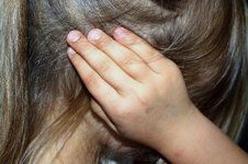 child covering her ears