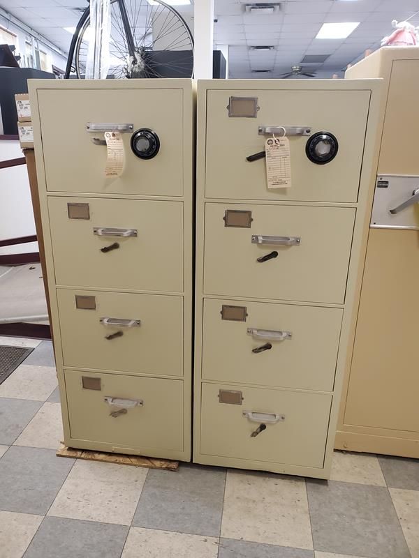 Two beige, four-drawer filing cabinets side-by-side inside a store.
