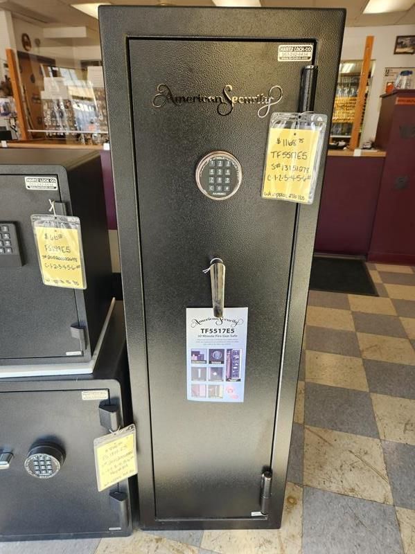 A black American Security gun safe with combination lock, price tags, in a store.