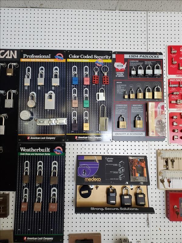 Lock display on a pegboard. Assorted padlocks of different sizes and colors, organized on product displays.
