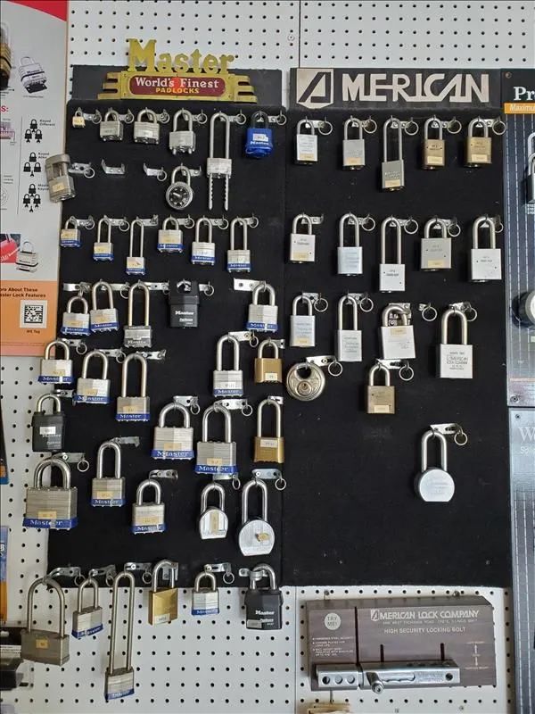 Lock display board featuring many different padlocks of various sizes and brands.