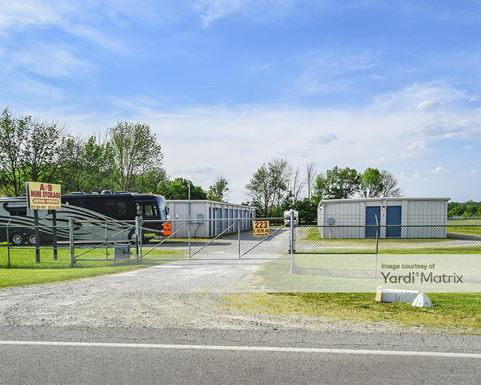 a rv is parked in front of a storage facility .