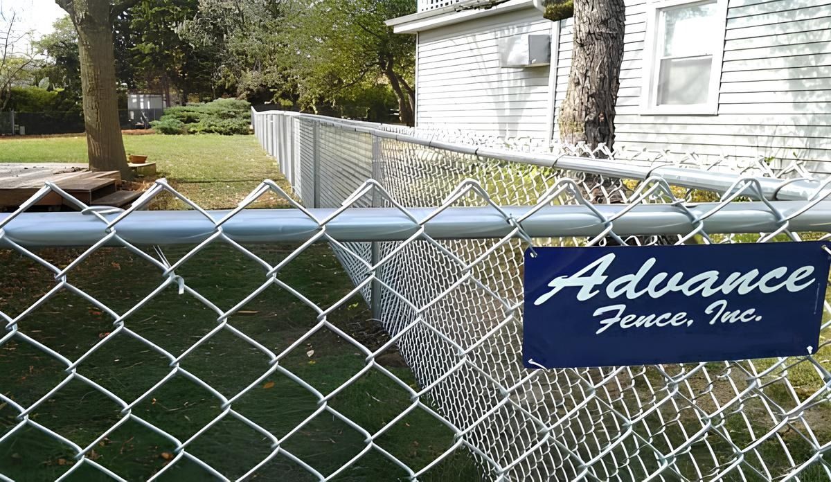 Chain-link fence with a sign for 