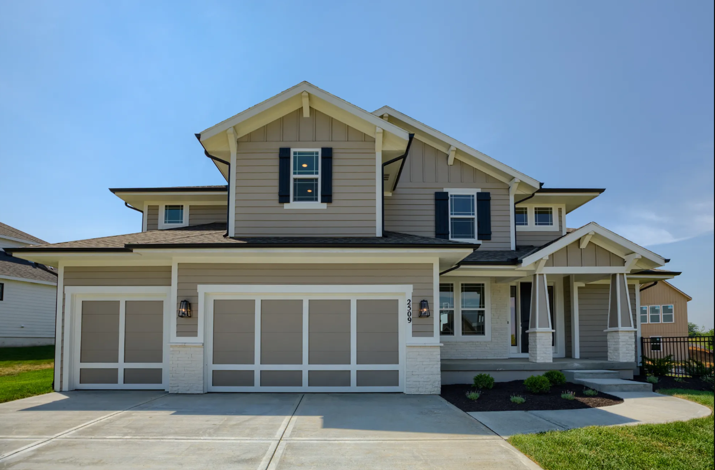 A large house with a large garage and a driveway