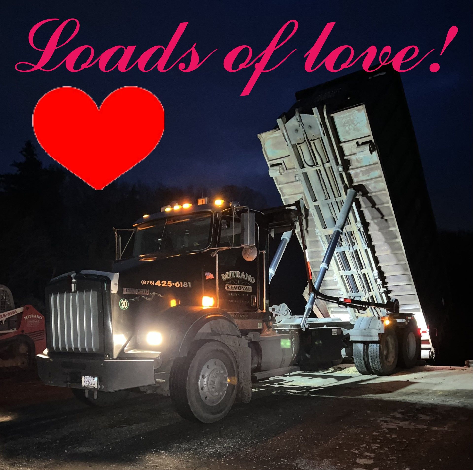 Black dump truck, lit at night, with tilted bed and red heart above, text: 