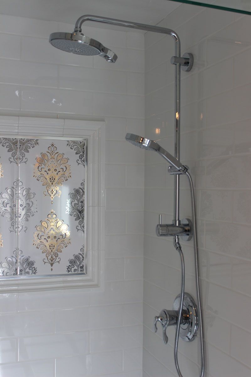 A shower head is hanging from the wall in a bathroom.