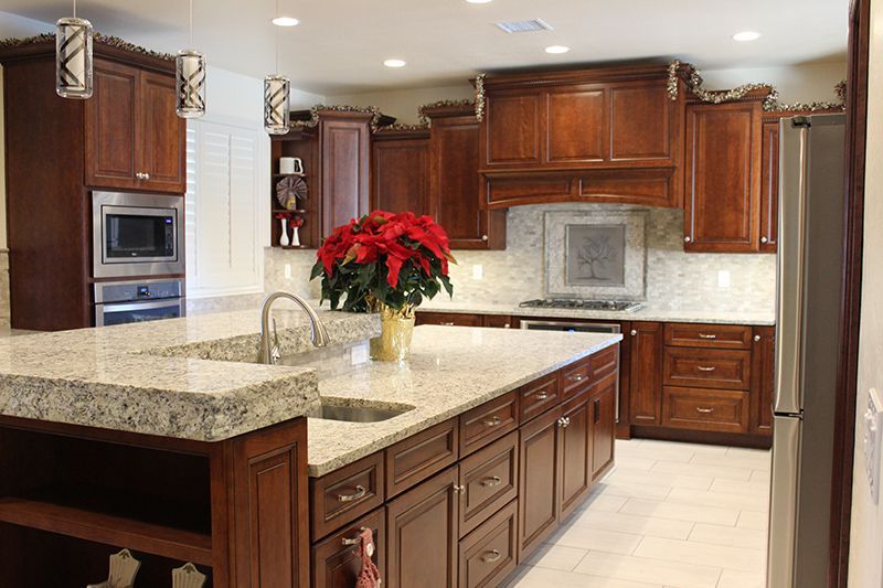 A kitchen with wooden cabinets and granite countertops