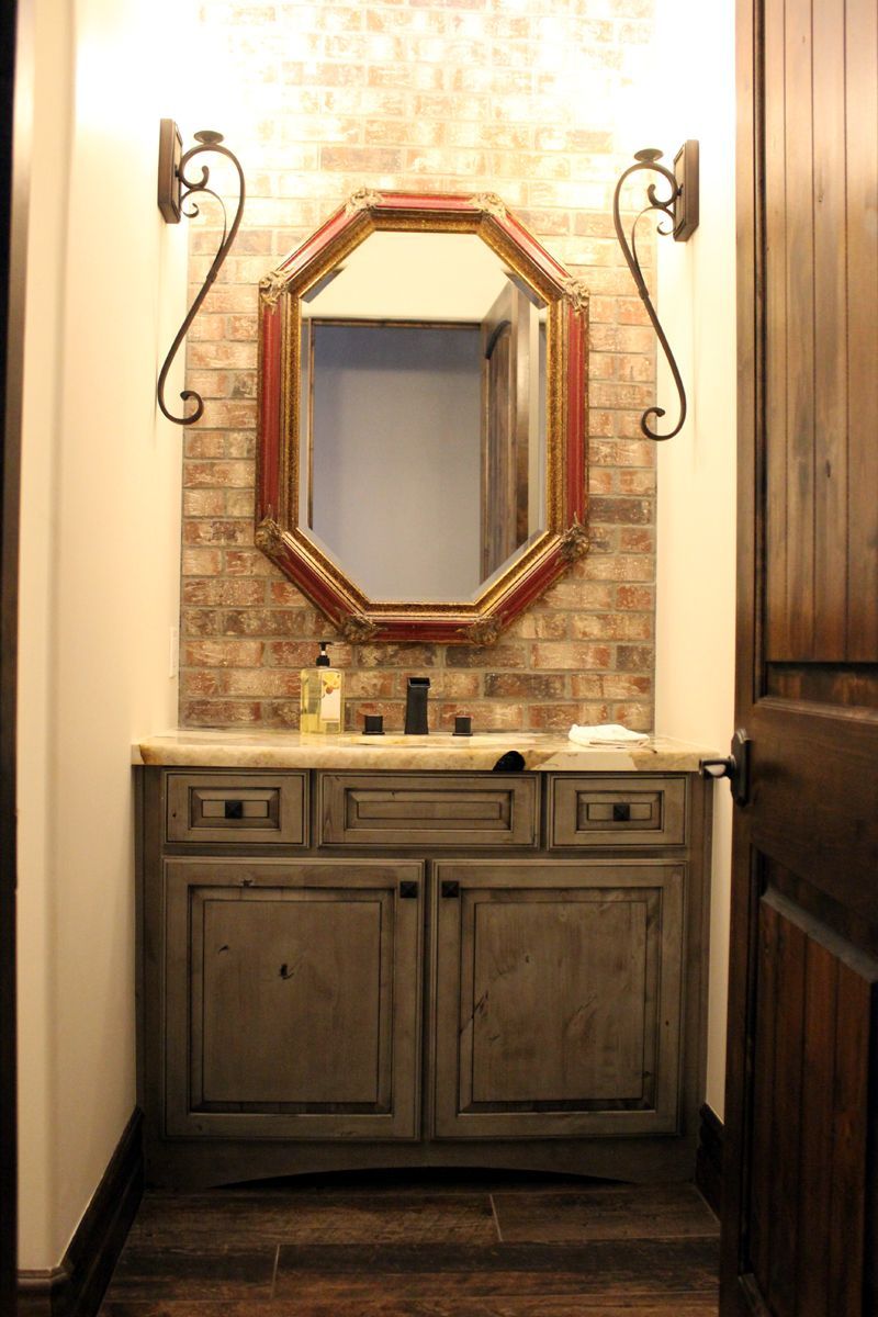 A bathroom with a sink and a mirror on the wall.