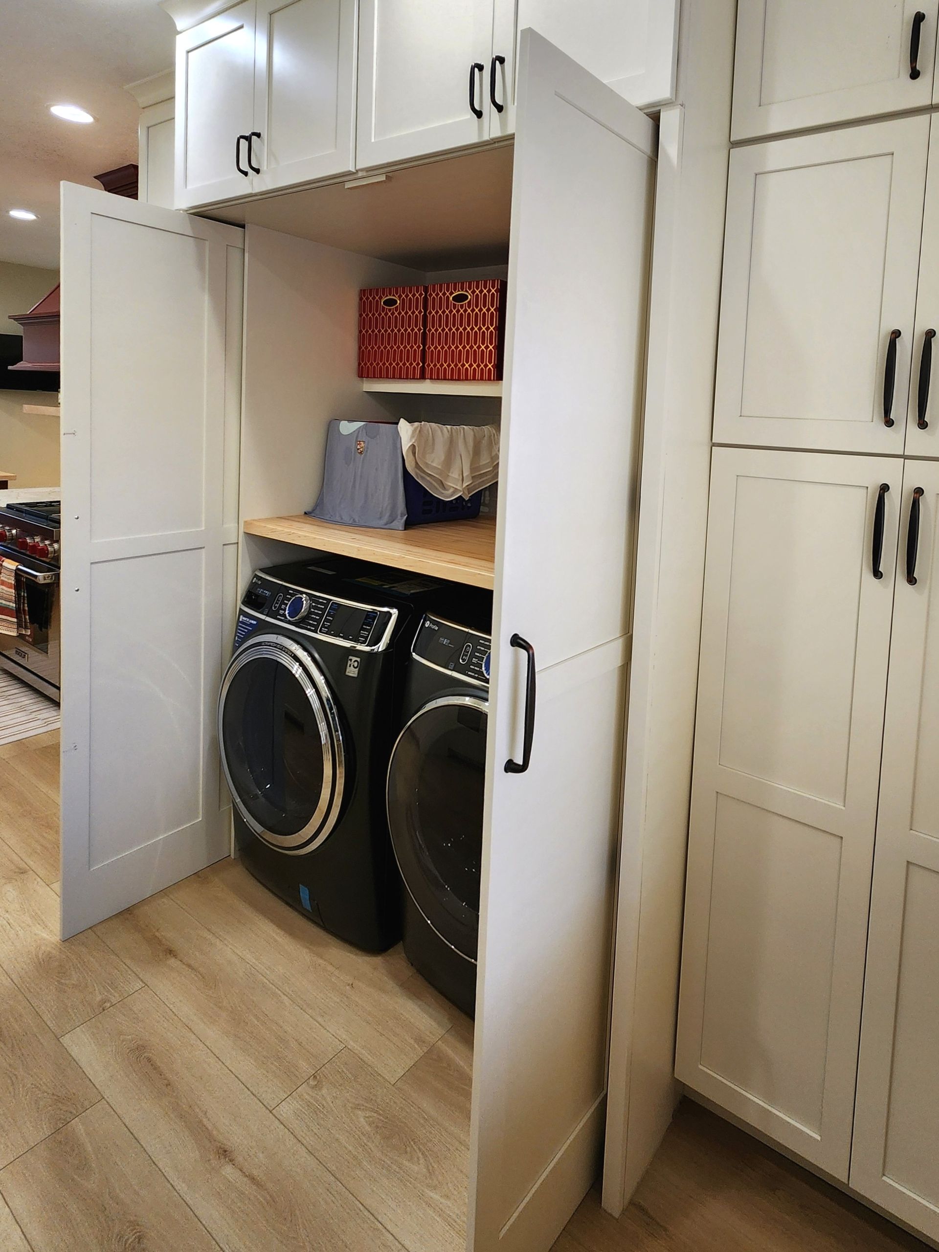 A laundry room with a washer and dryer in a cabinet.