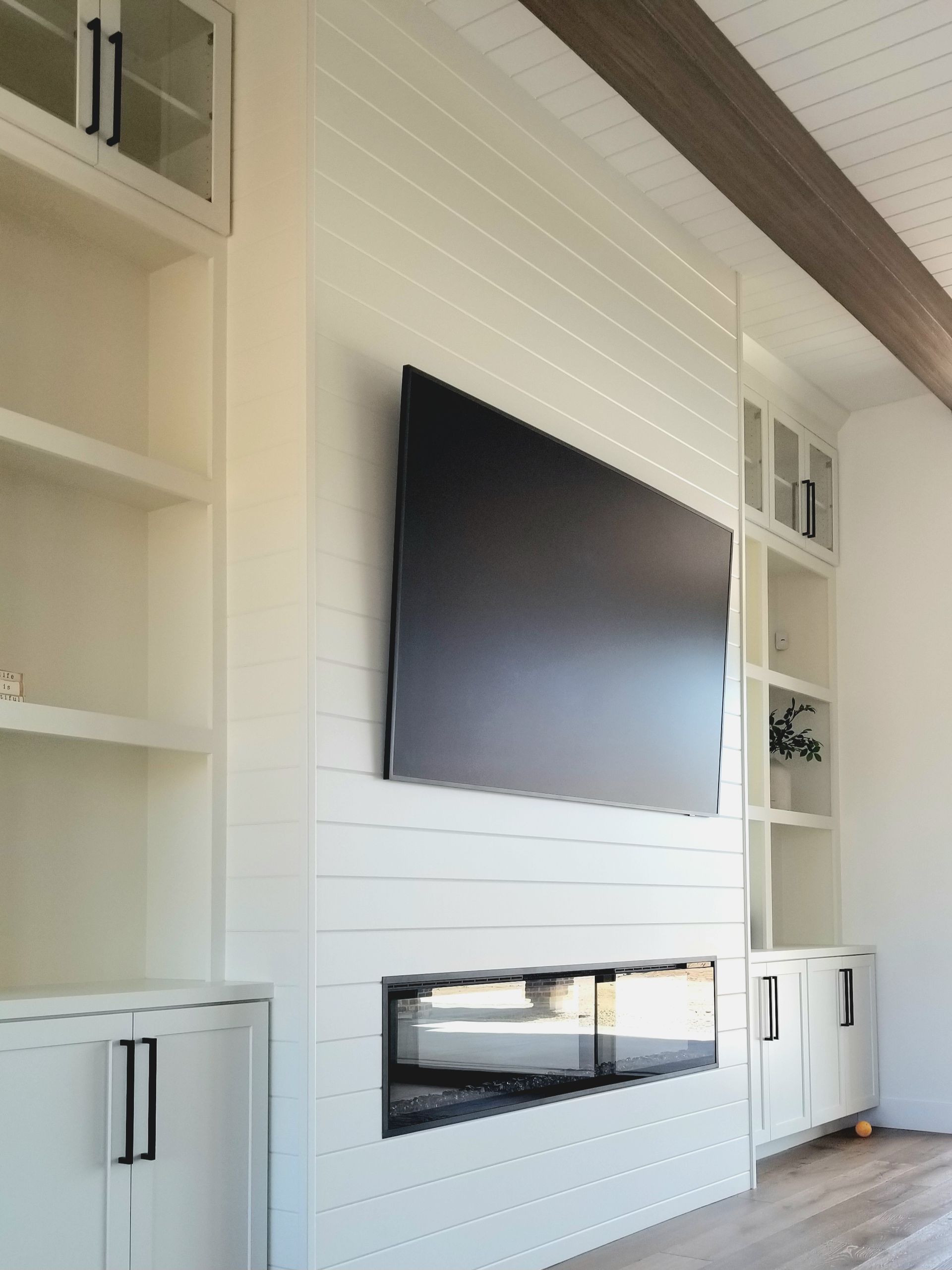 A living room with a flat-screen tv mounted on the wall