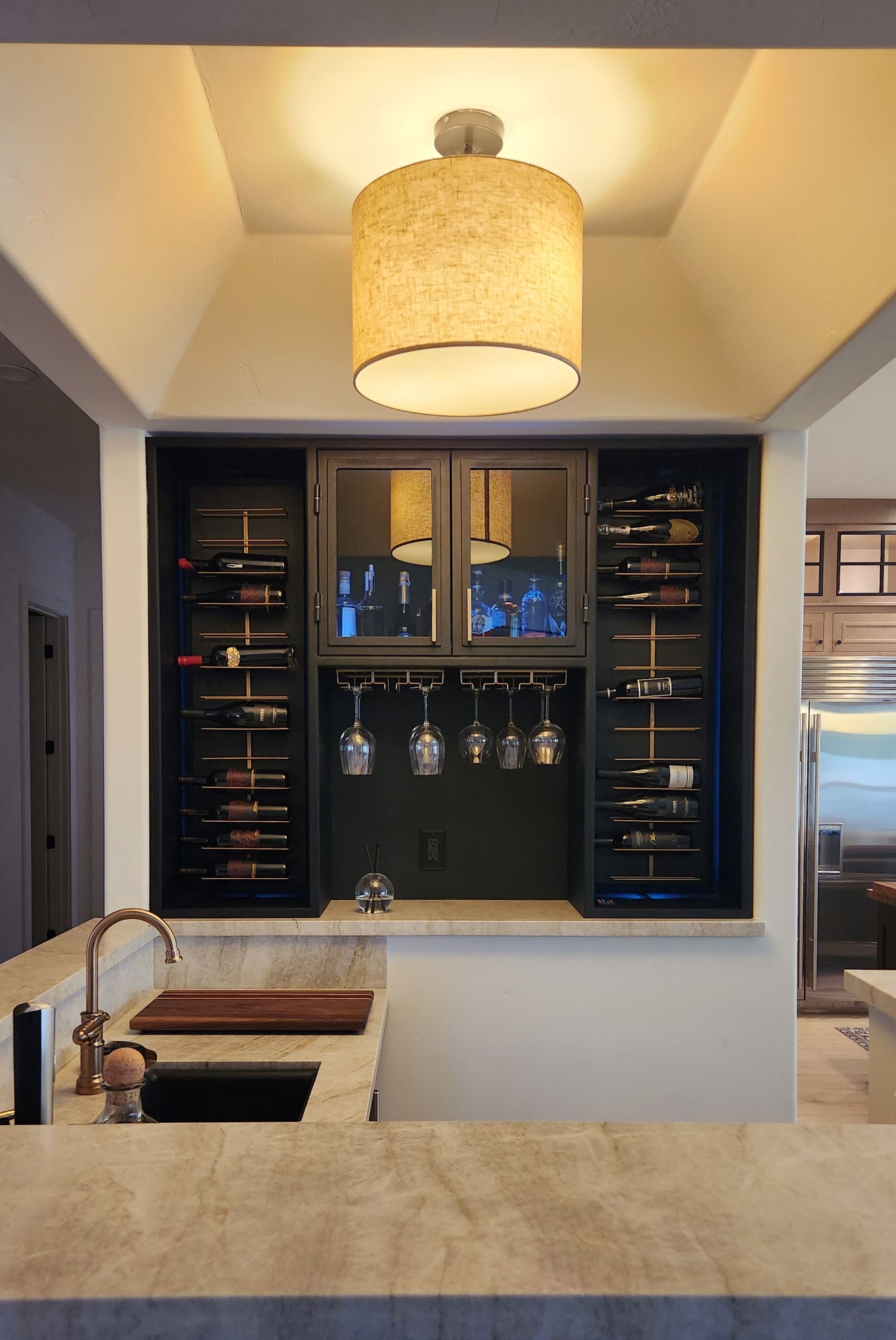 A kitchen with a wine rack and a sink