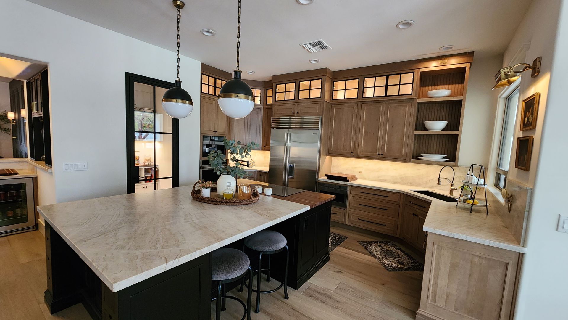 A kitchen with a large island in the middle of it.