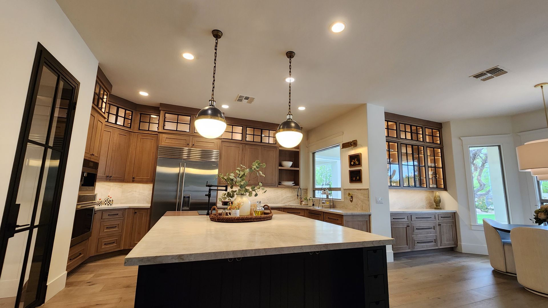 A kitchen with a large island and stainless steel appliances
