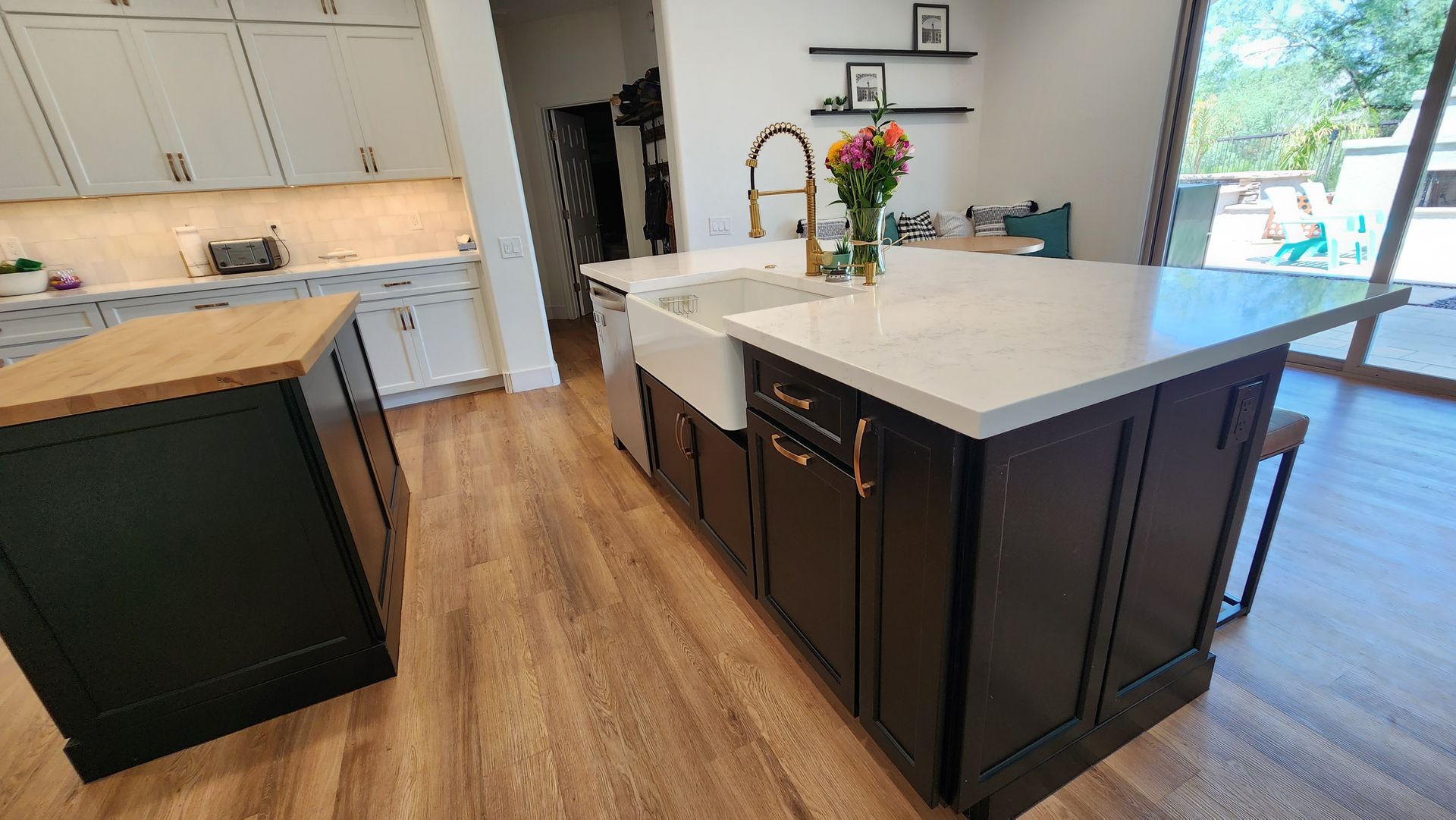 A kitchen with a large island and a sink.