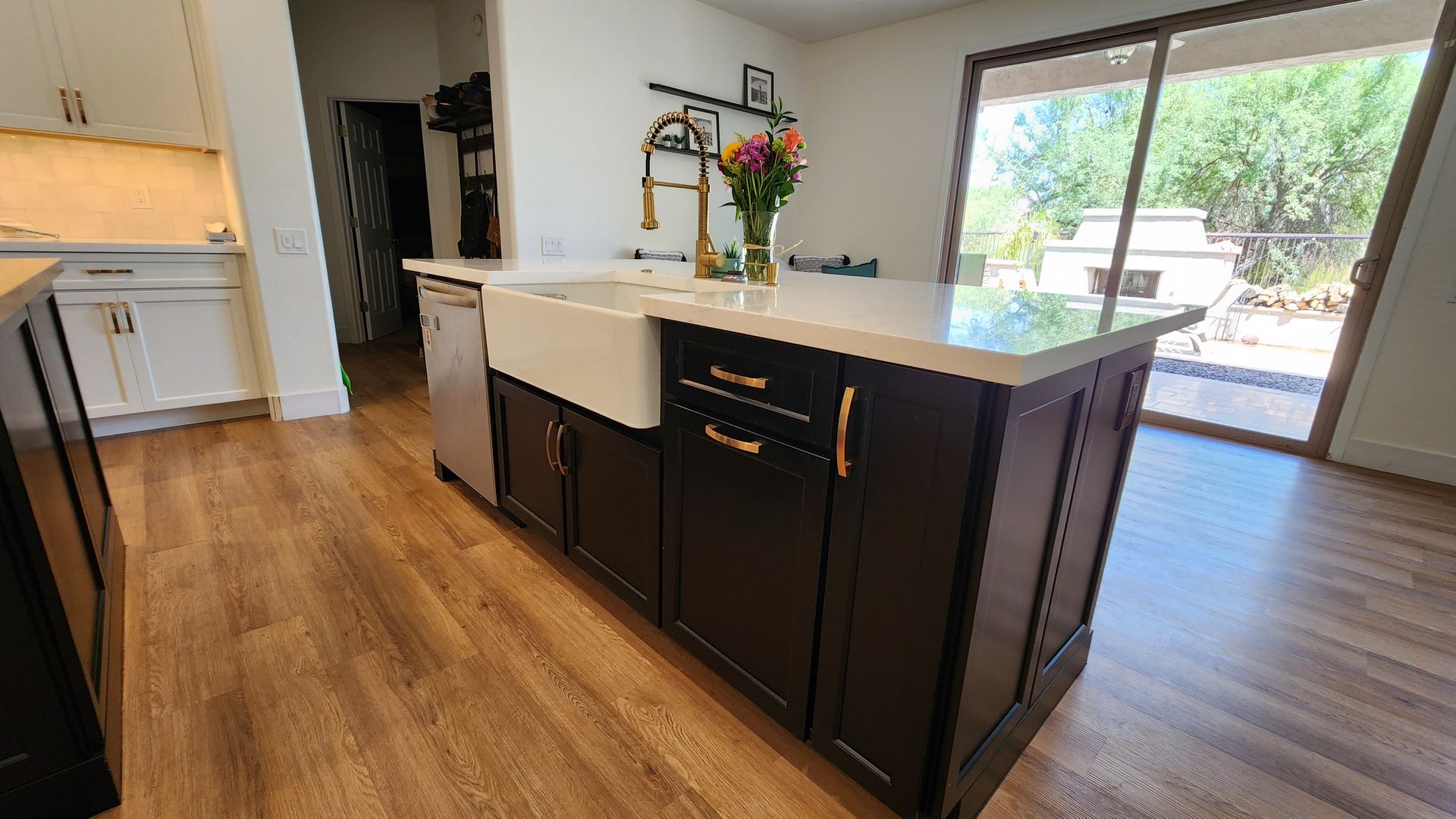 A kitchen with a large island and a sink.