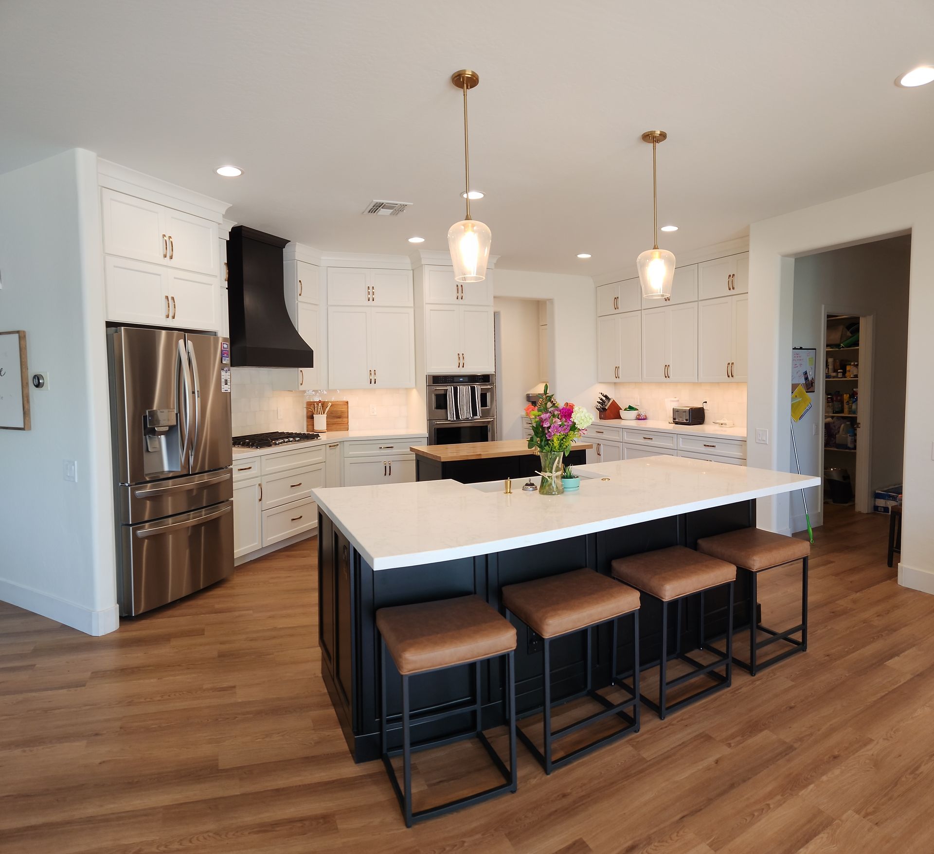 A kitchen with a large island and stools