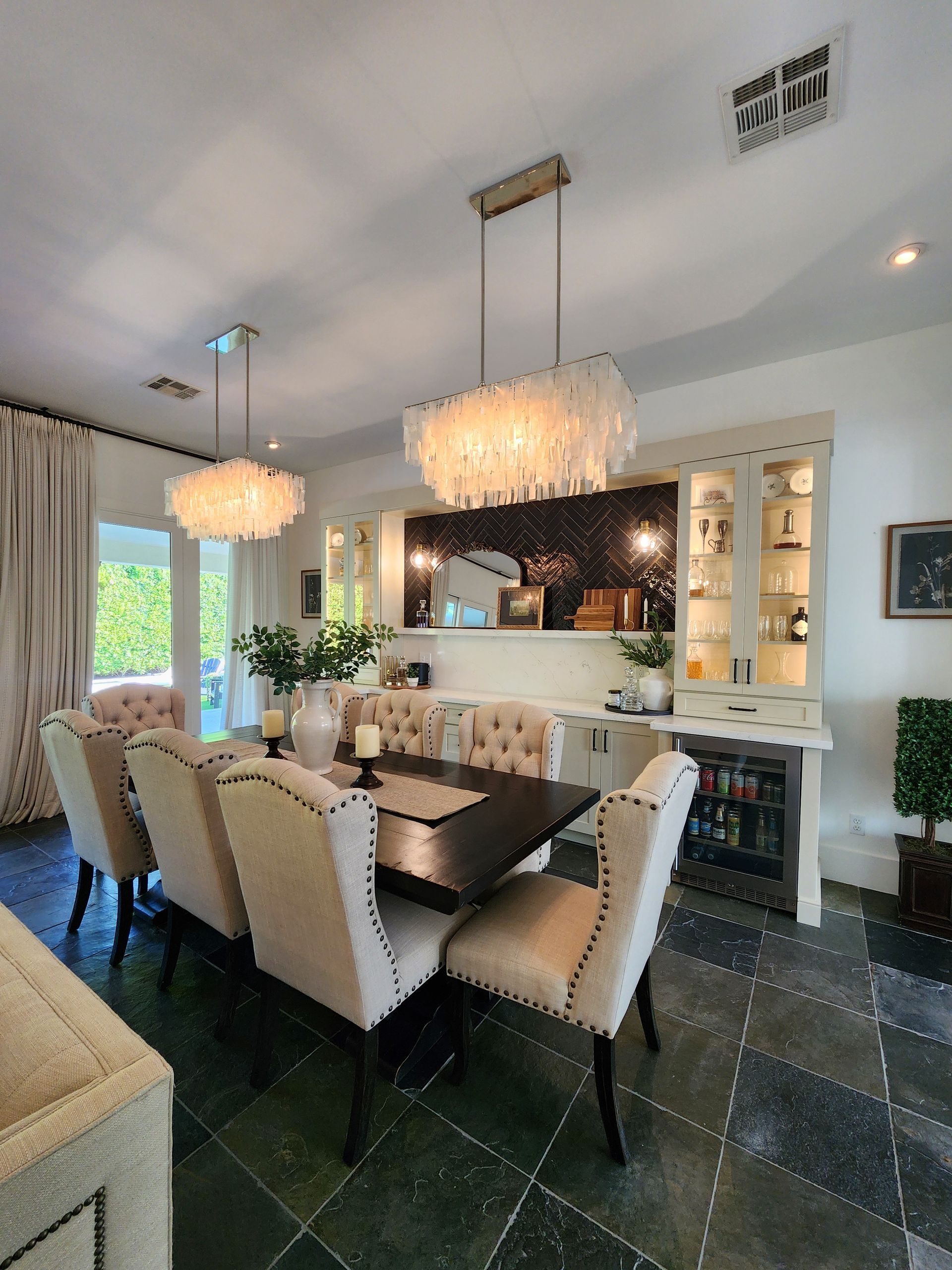 A dining room with a long table and chairs