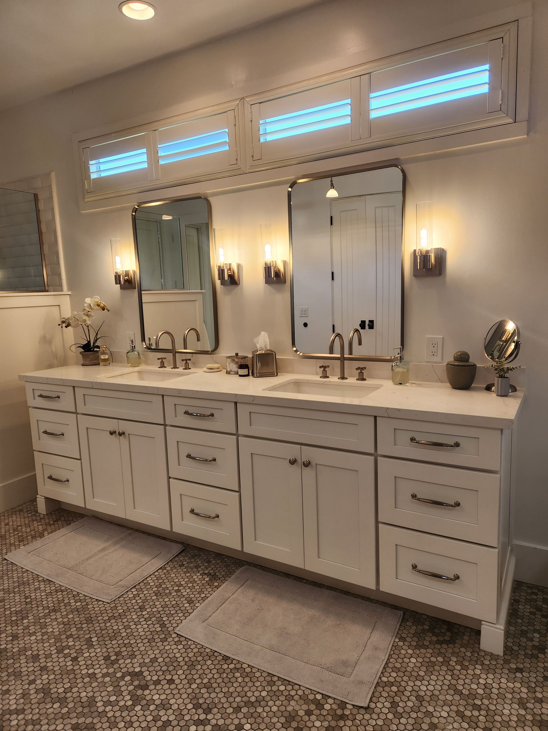 A bathroom with two sinks and two mirrors.