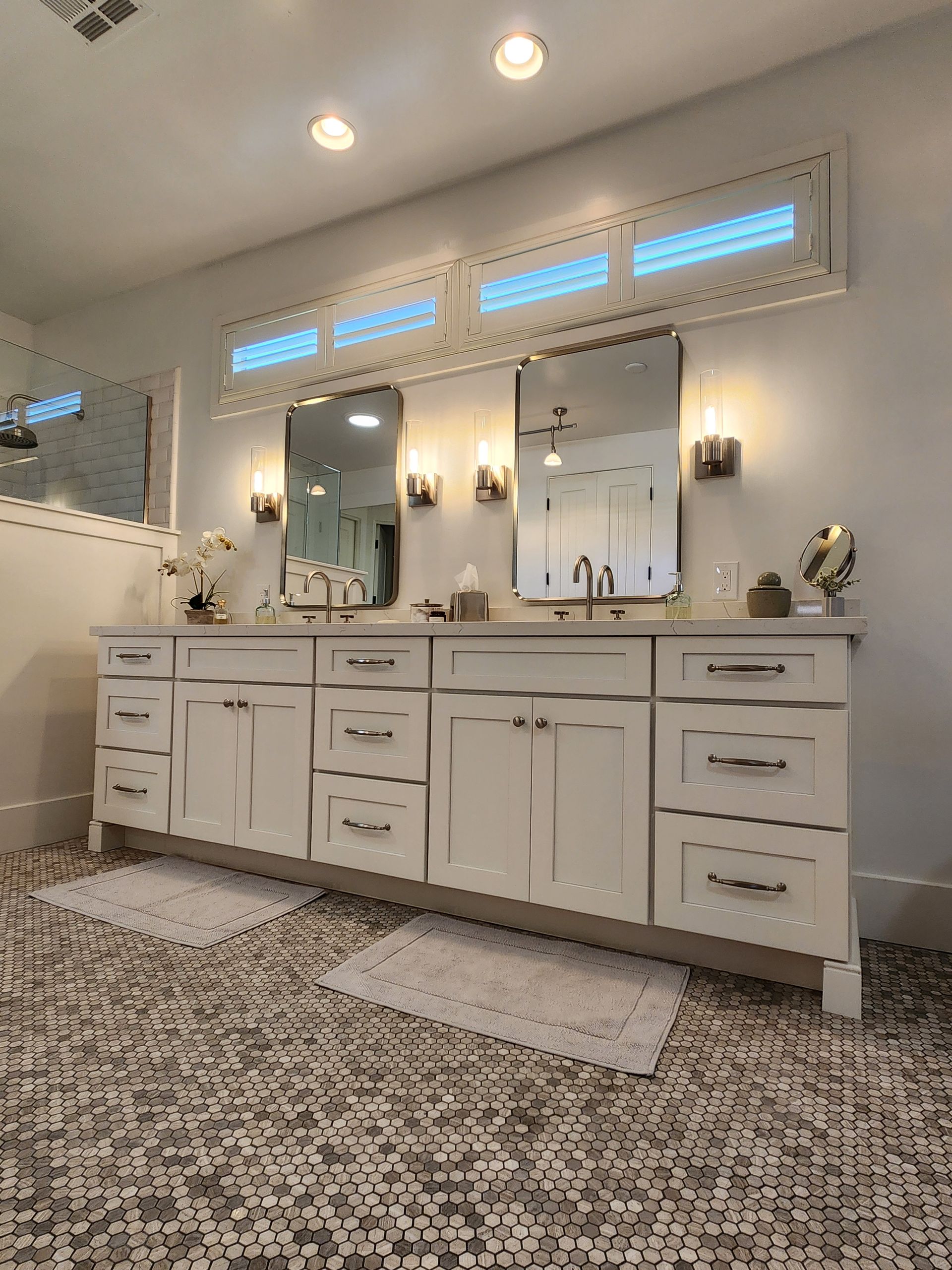 A bathroom with two sinks and two mirrors.
