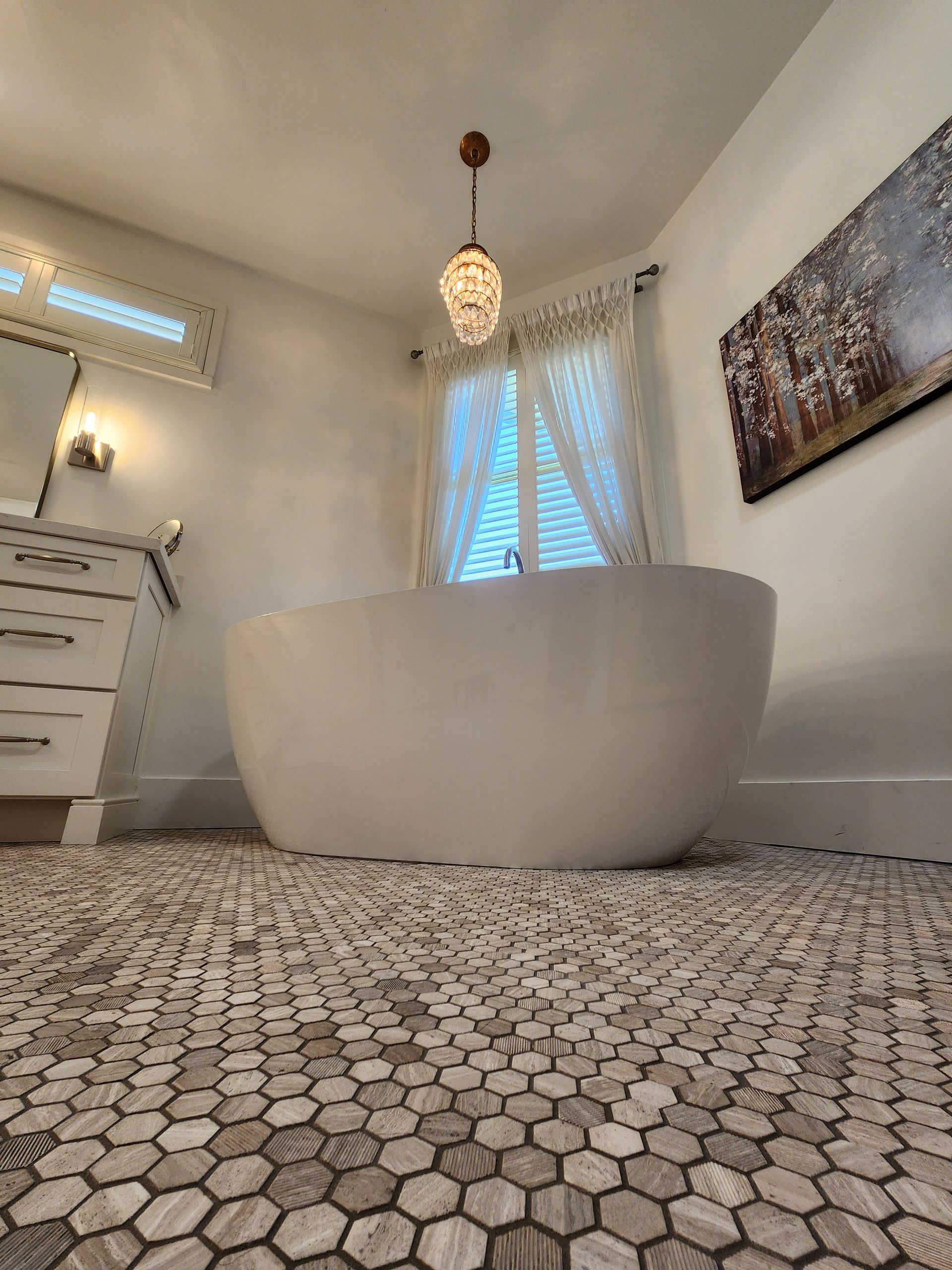 There is a bathtub in the middle of the bathroom.