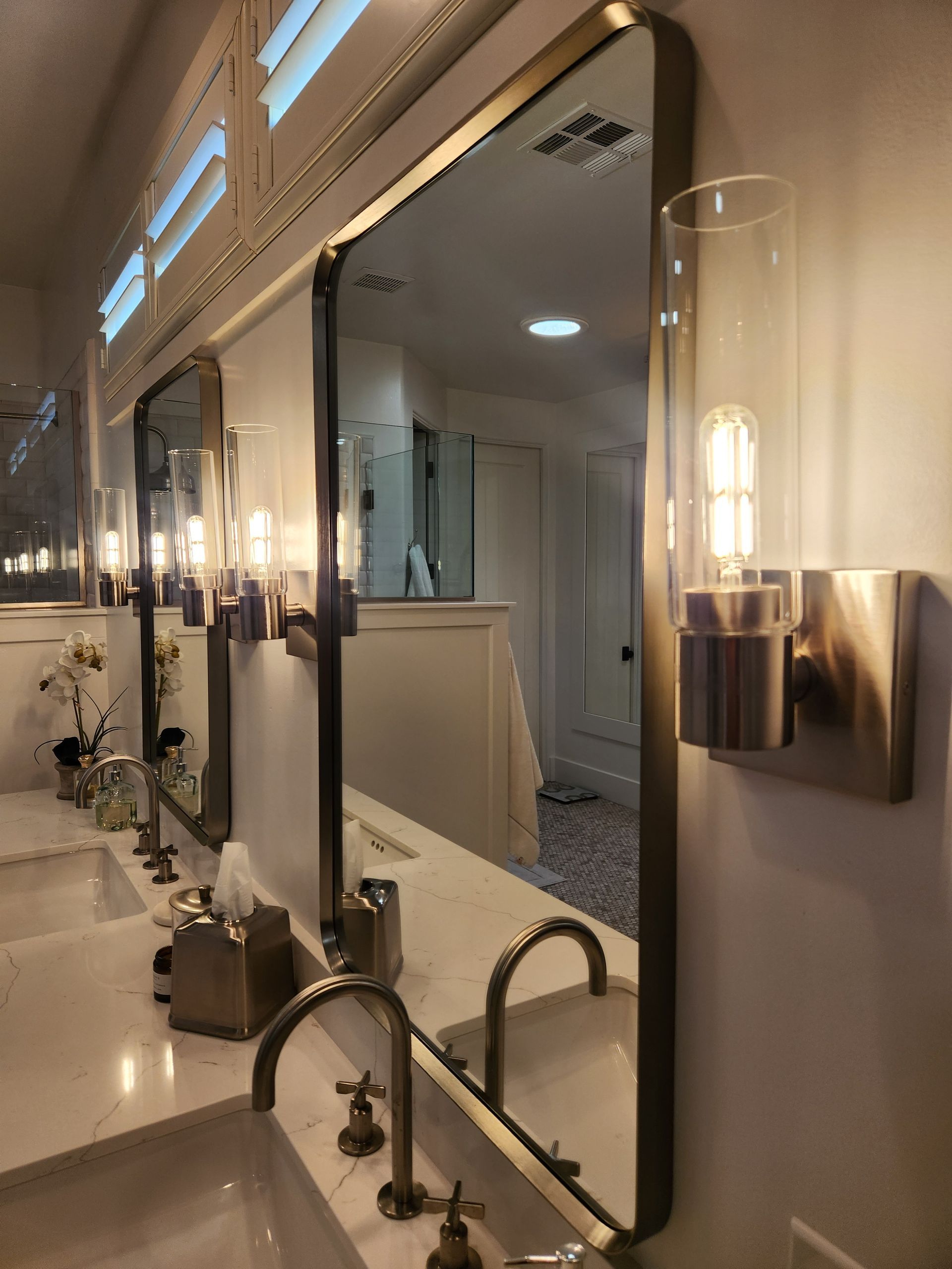 A bathroom with two sinks and two mirrors.