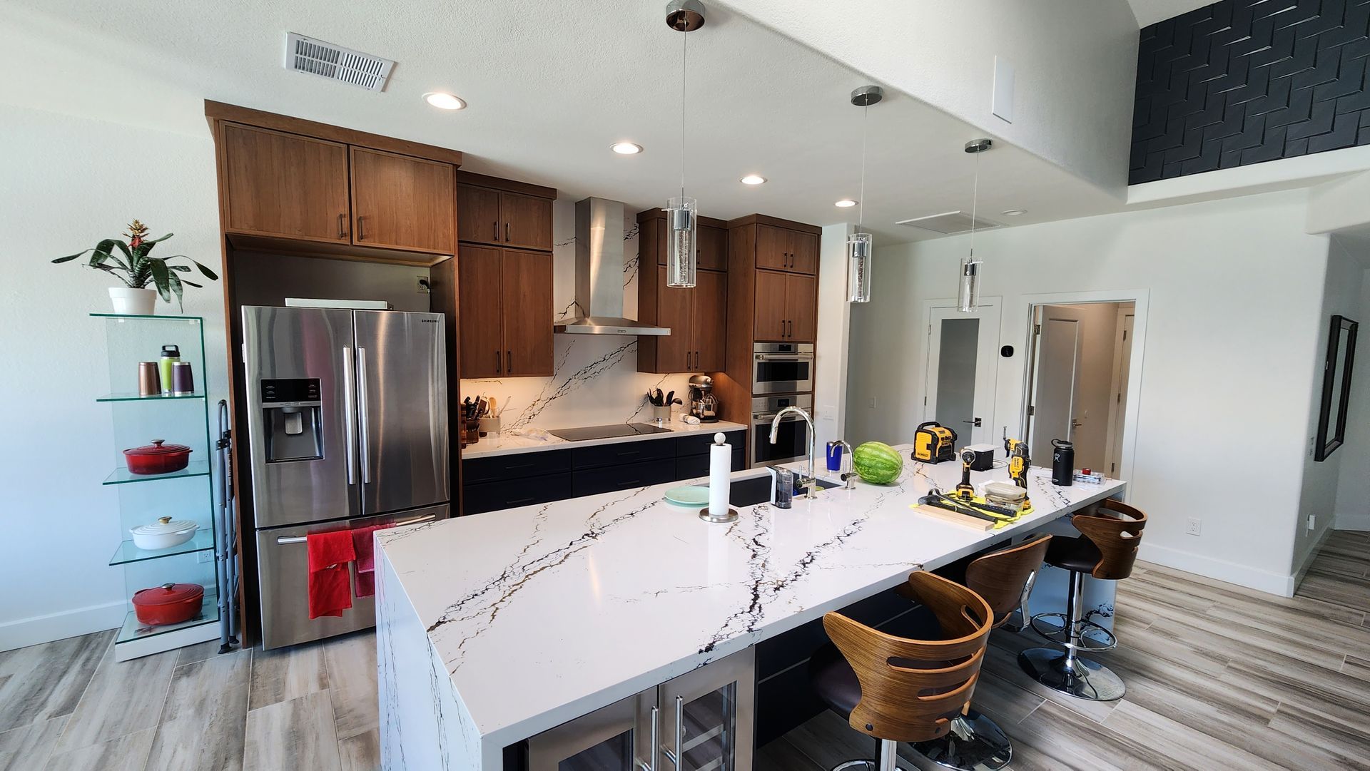 A kitchen with stainless steel appliances and a large island.
