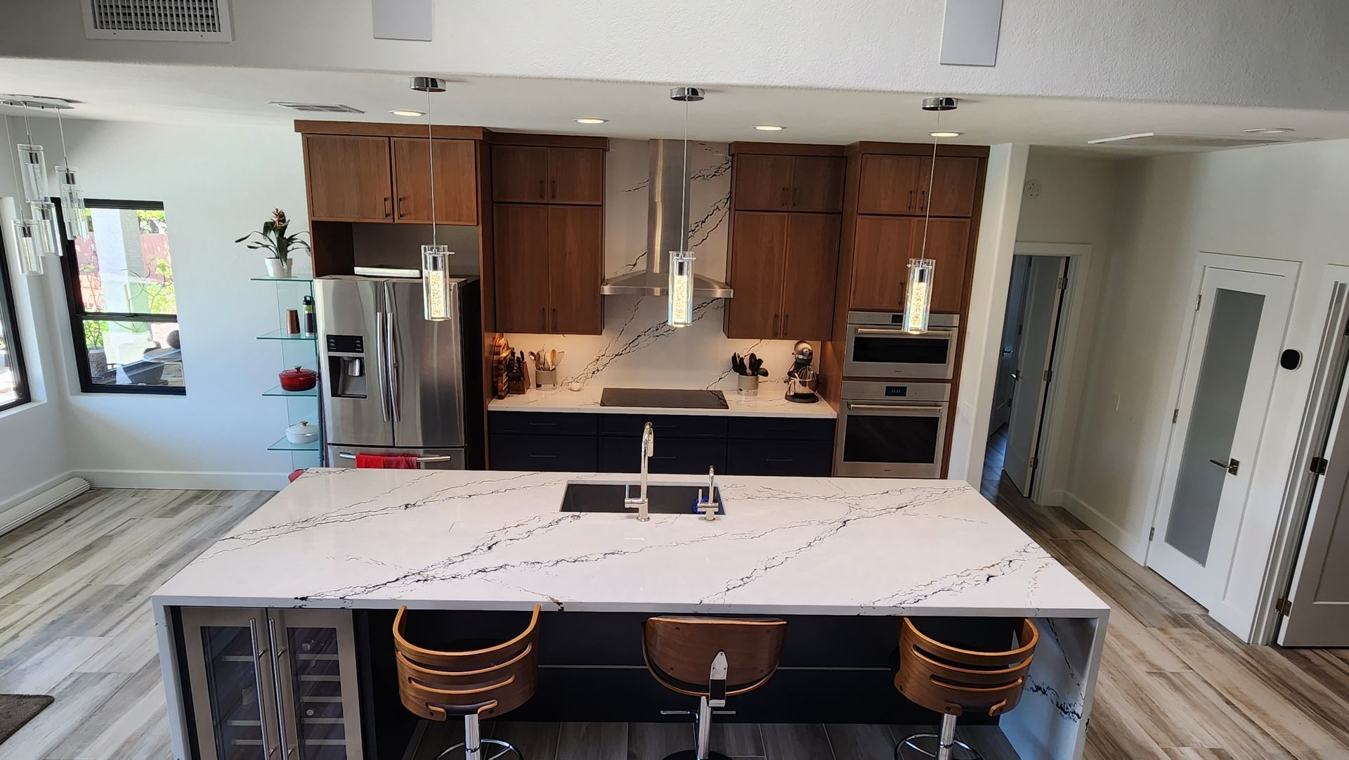A kitchen with stainless steel appliances and wooden cabinets