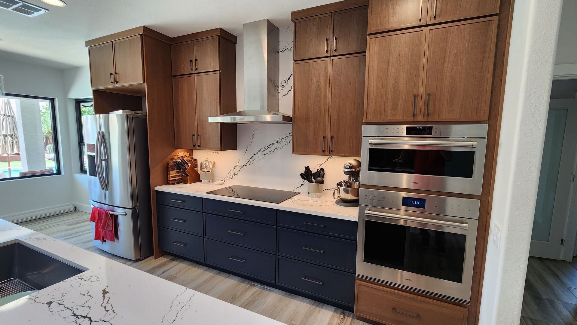 A kitchen with stainless steel appliances and wooden cabinets.