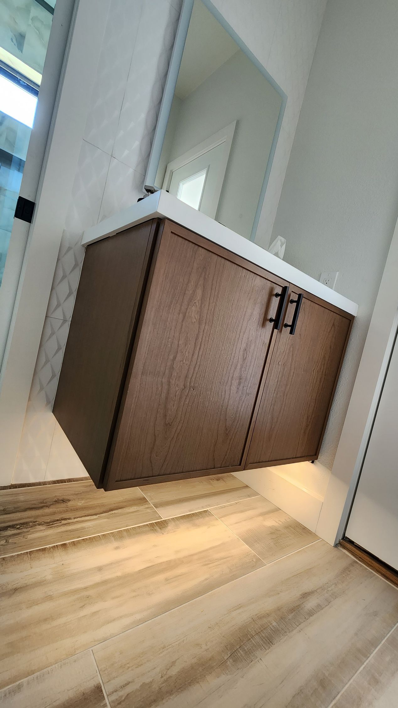 A nice-looking bathroom with a sink, mirror, and wooden cabinets.