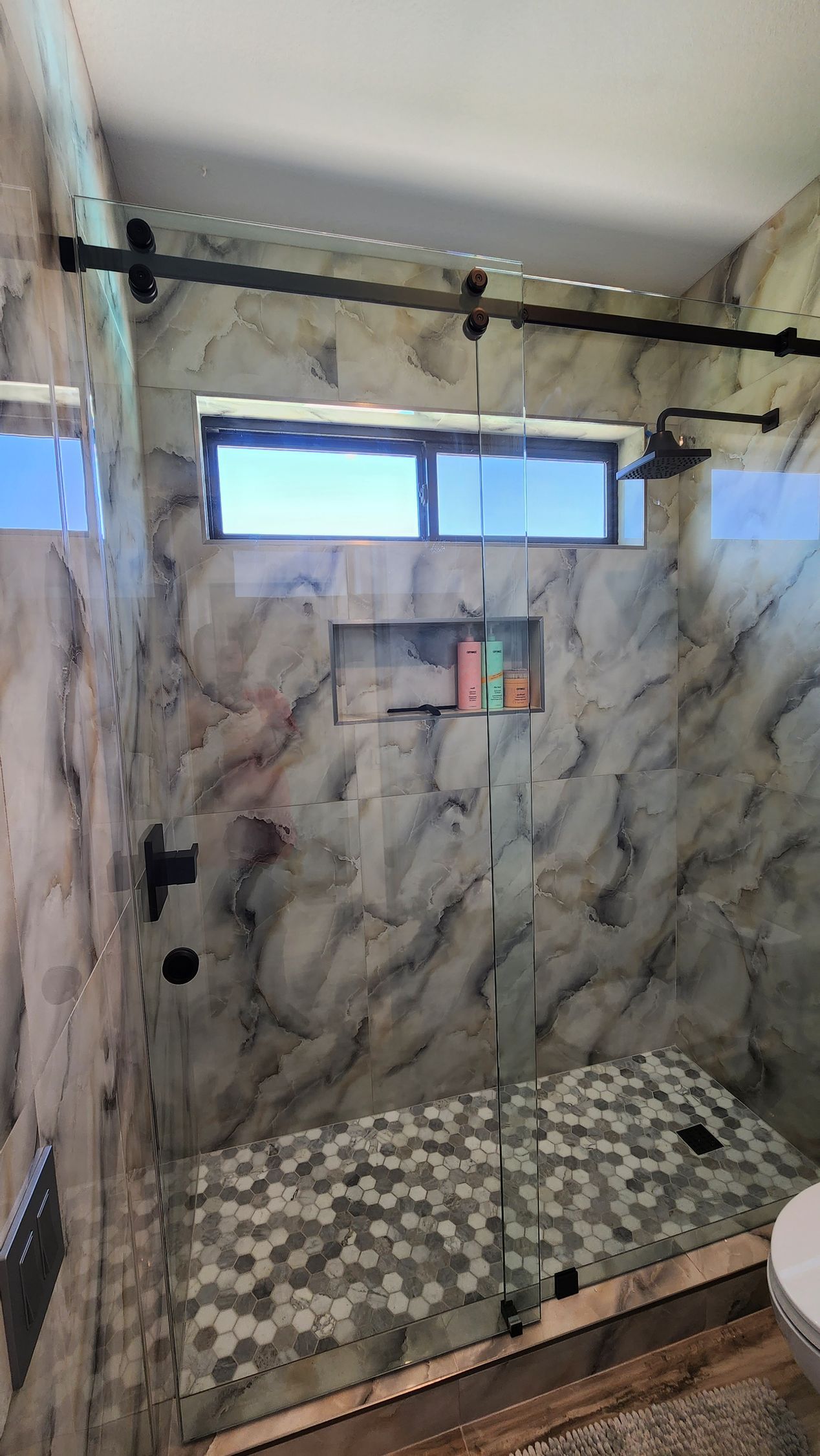 A nice-looking bathroom with a walk-in shower and a window.