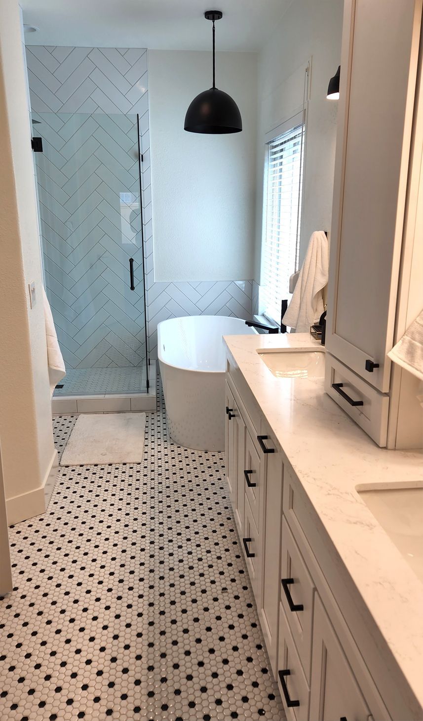 A bathroom with a bathtub, sink, and shower.