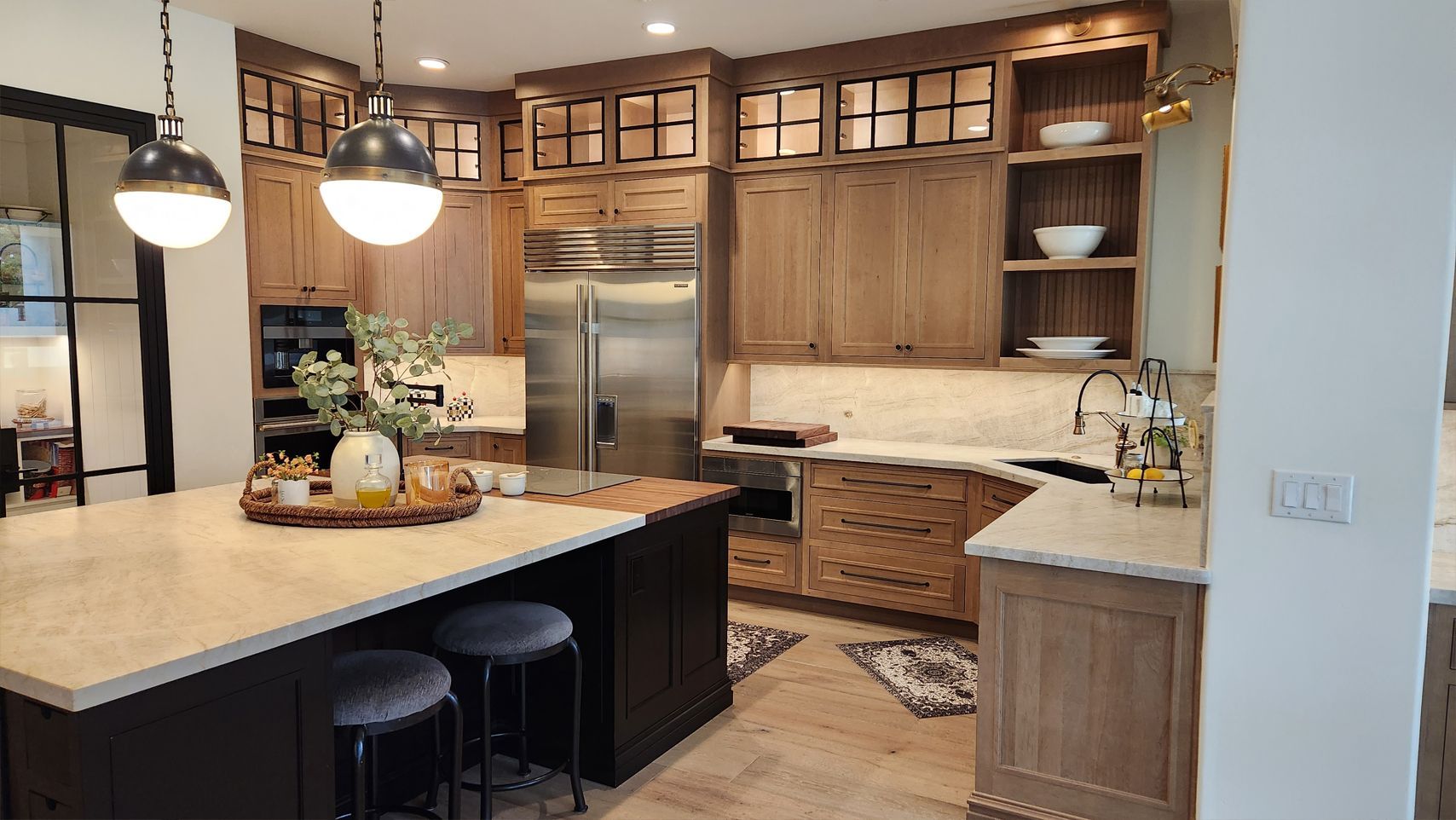 A kitchen with stainless steel appliances and wooden cabinets