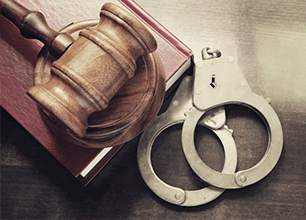 Handcuffs, gavel and book