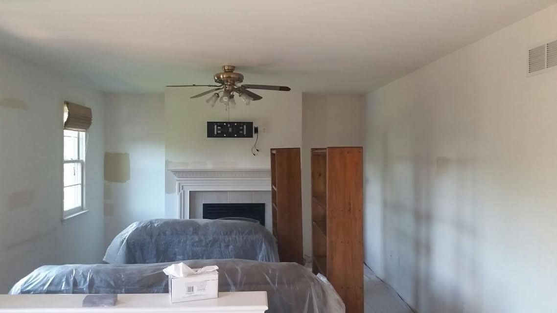 An empty basement with a wooden ceiling and shelves.