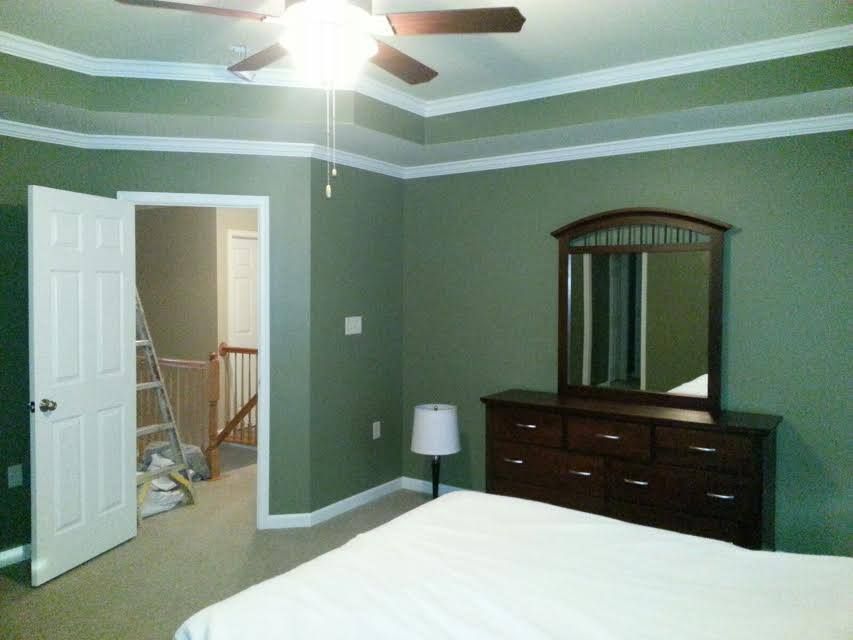 A kitchen with wooden cabinets , a stove , a microwave , and a sink.